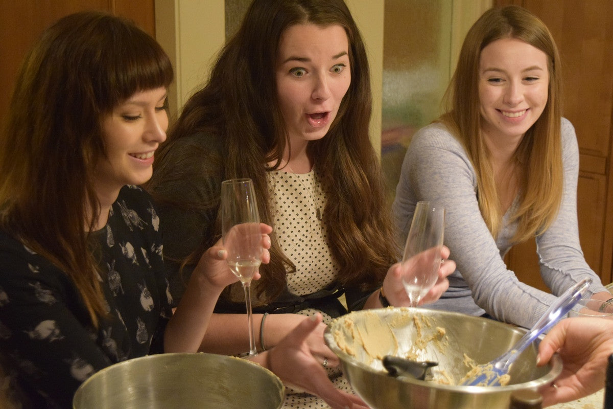 Women enthusiastically enjoying first at home cookie baking class